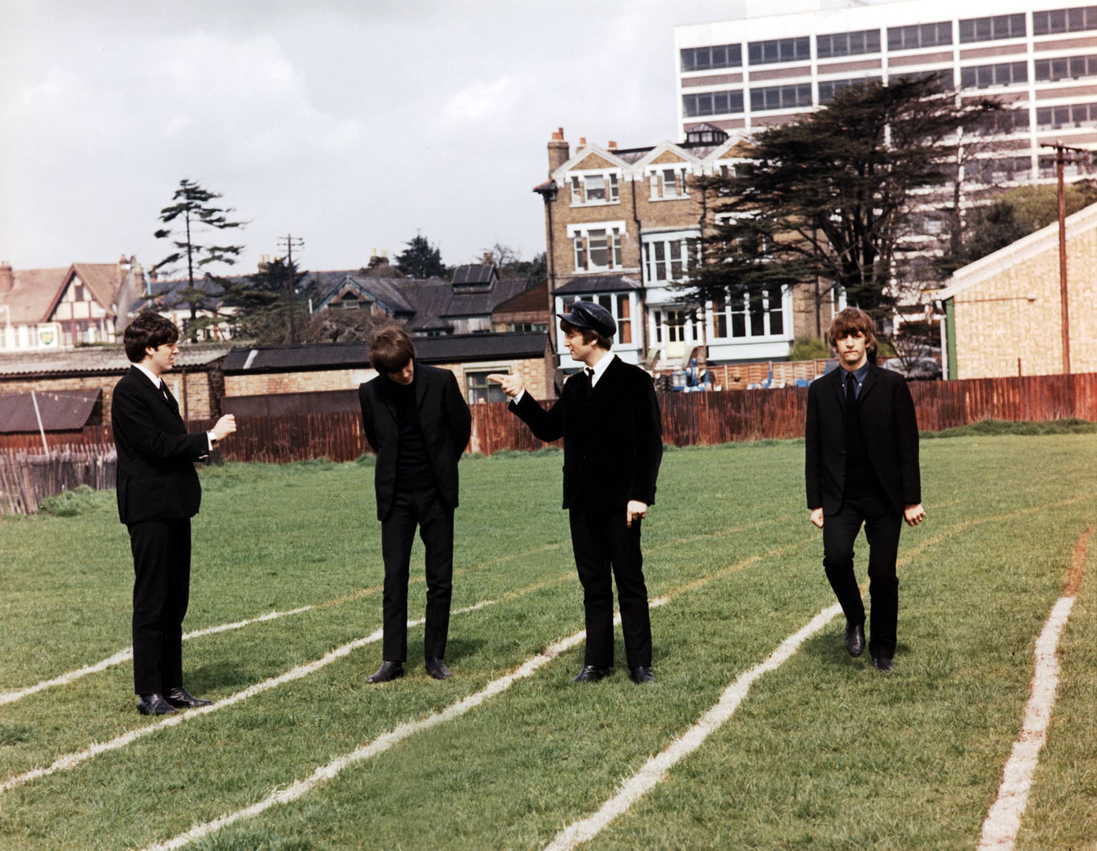 The Beatles: Paul McCartney, George Harrison, John Lennon, Ringo Starr pose on a cricket field, during the production of A HARD DAY'S NIGHT, 1964
