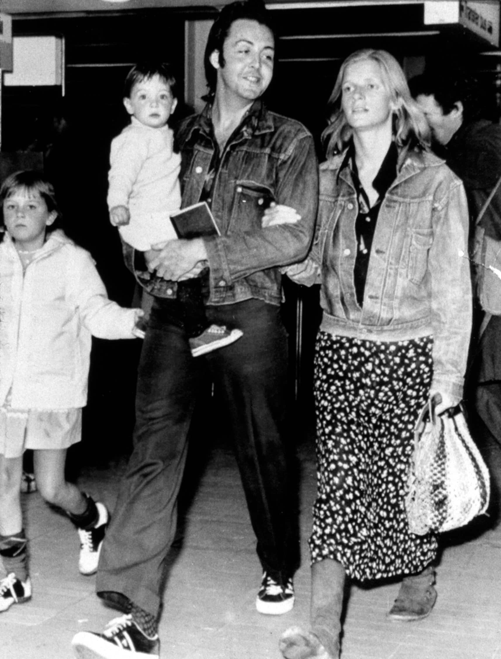 Paul and Linda McCartney with children Heather and Mary at airport, 1971