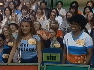 Vanna White on The Price is Right, seen wearing a shirt reading Get Serious