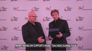 Barry Manilow personally presented Elmore with prize money that will change his school