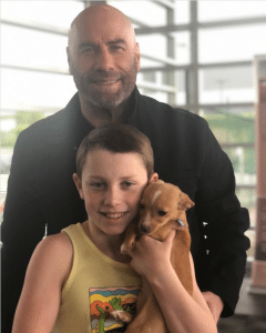 John and Benjamin Travolta with the newest fluffy family member