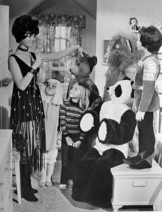 Erin Murphy as young Tabitha Stephens on Bewitched, wearing a classic 1960s outfit with a sweet smile.