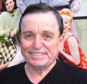 Jerry Mathers smiling while interacting with fans at a convention