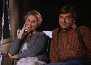 Michael Learned and Ralph Waite smiling together during a break on The Waltons set